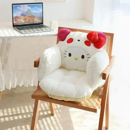 a hello kitty chair sitting in front of a laptop computer