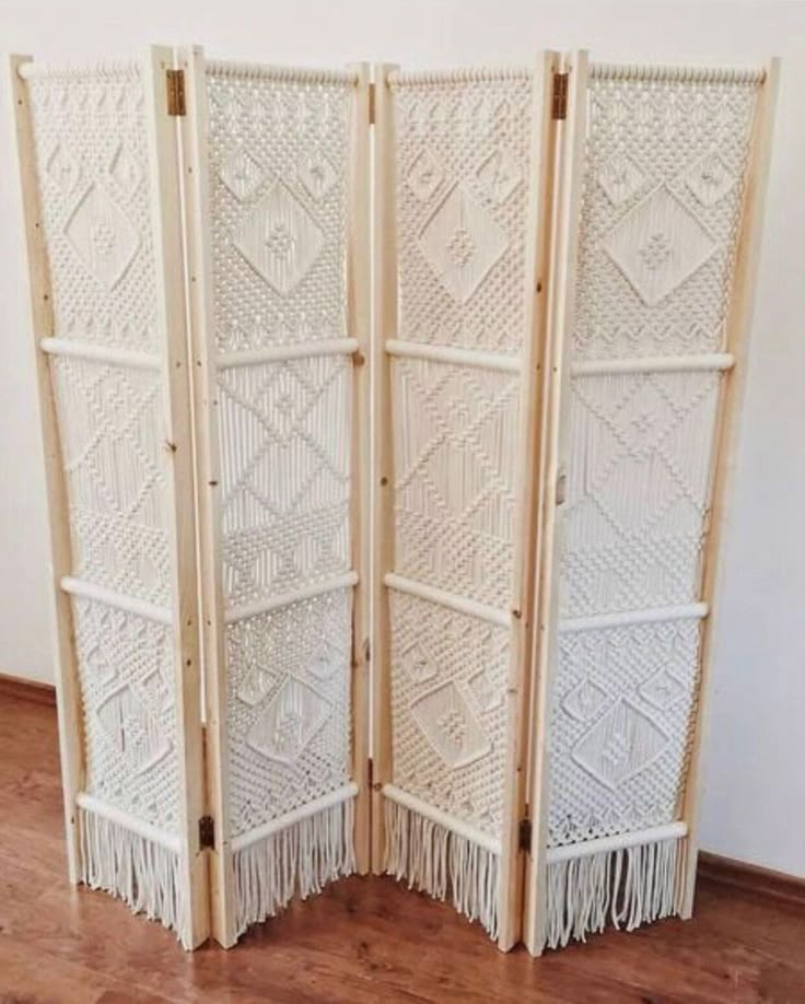 two white woven screens sitting on top of a wooden floor