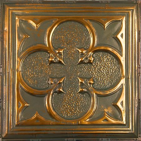 an intricately designed metal plate with gold paint on the top and bottom, is shown