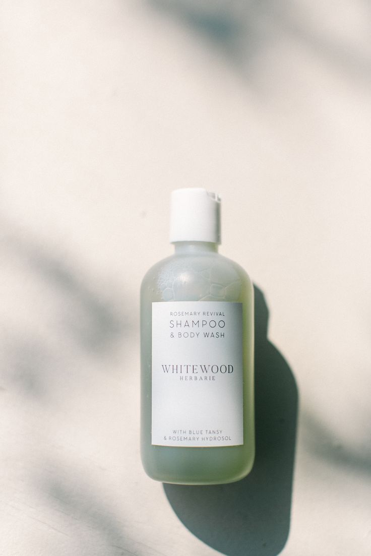 a bottle of white soap sitting on top of a table