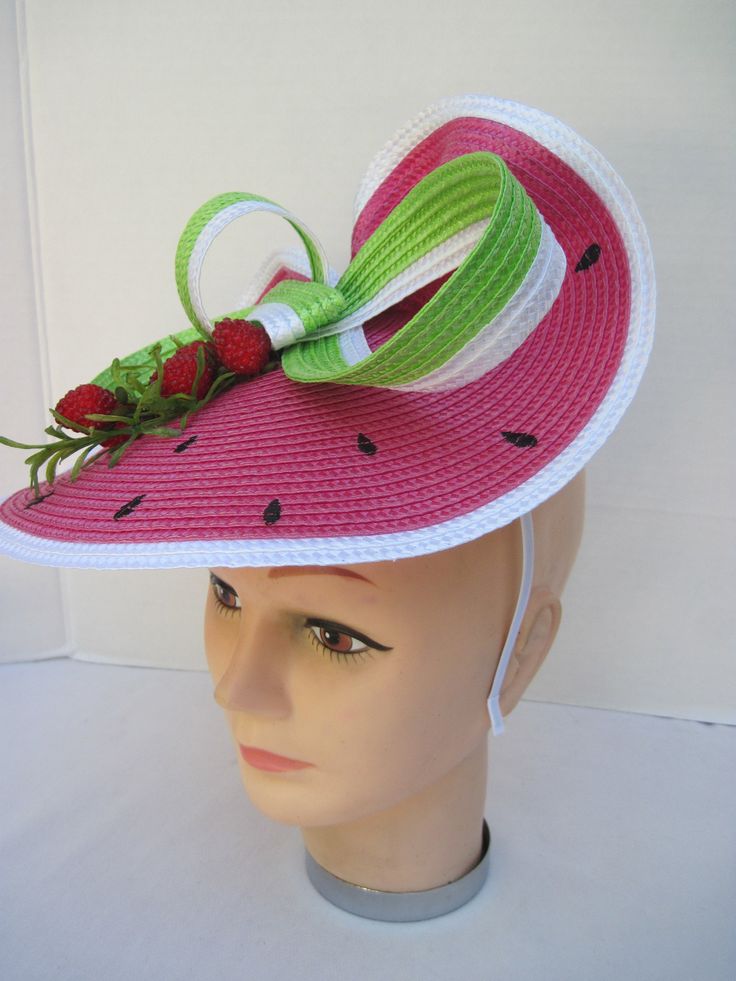 "* This design features the watermelon braiding as the hat foundation folded into design loops complemented by red raspberries and summer greens. * The hat form is about 12\" folded in back and tilted in a sophisticated design. * It is light weight, balanced and comfortable to wear year round. * Designed on a satin covered metal headband, it fits just about any head size and when viewed from any direction it looks complete, striking and eye catching. * Wear it throughout the year for special eve Green Short Brim Sun Hat For Kentucky Derby, Pink Summer Costume Hats And Headpieces, Green Adjustable Hat Bands For Kentucky Derby, Adjustable Green Hat Bands For Kentucky Derby, Adjustable Green Hat Band For Kentucky Derby, Fun Pink Costume Hats And Headpieces For Summer, Red Summer Hats For Garden Party, Red Mini Hats For Spring Beach Outings, Red Mini Hats For Beach In Spring