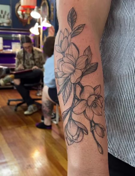 a person with a flower tattoo on their arm