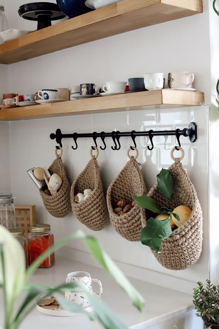 several baskets hanging on the wall in a kitchen