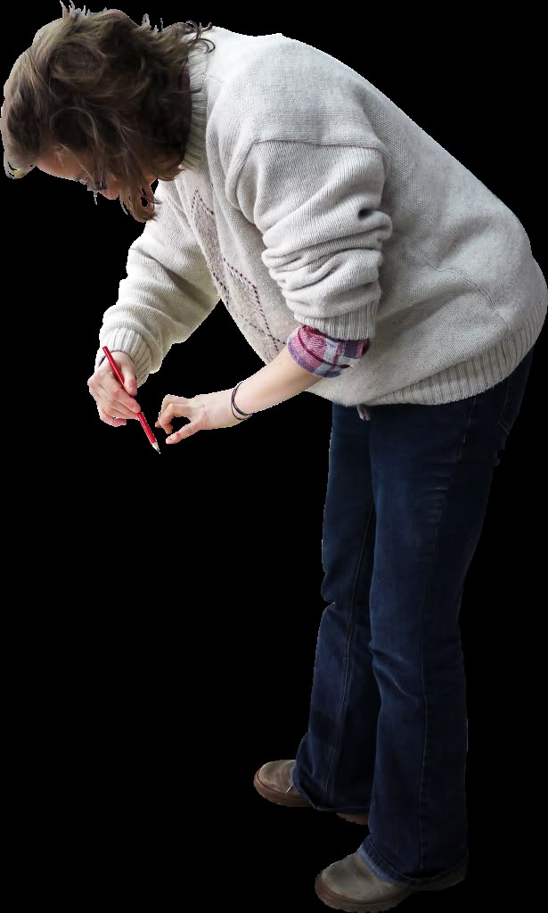 a woman holding a pair of scissors in one hand and looking down at the other