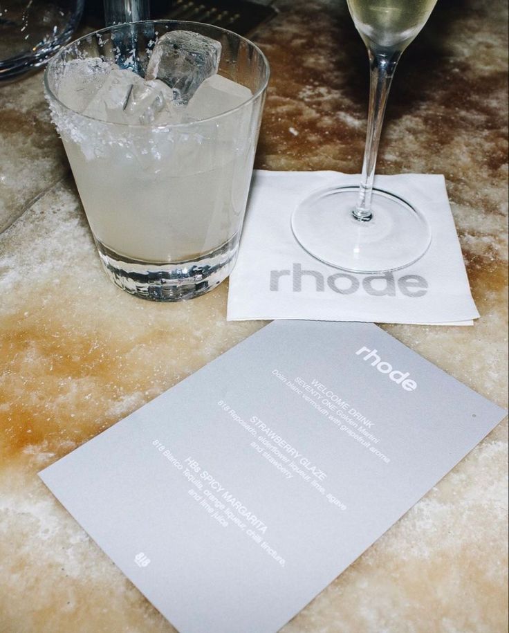 a table topped with two glasses and a menu