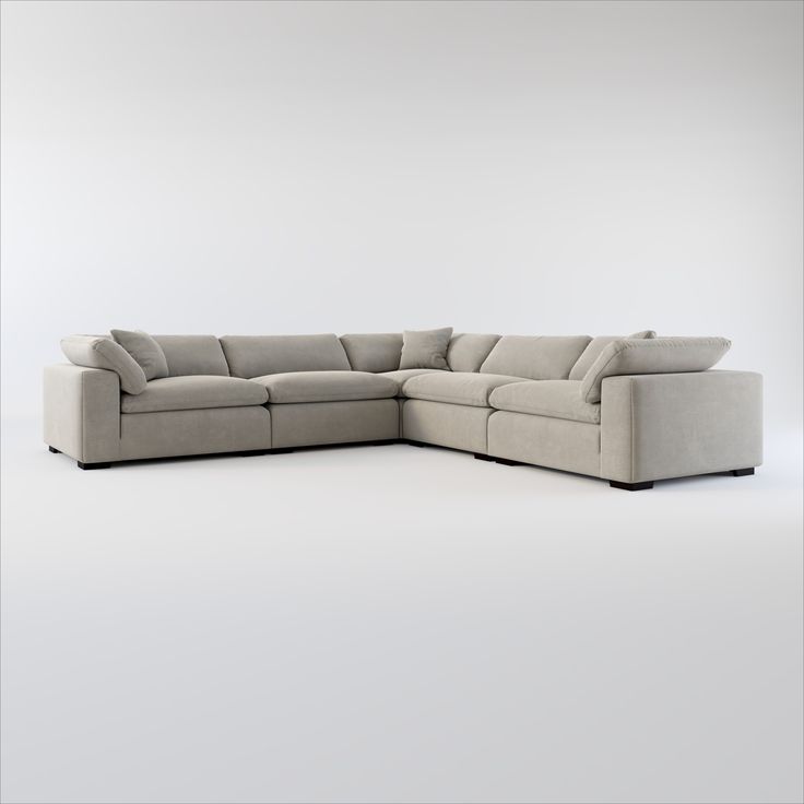 a large sectional couch sitting on top of a white floor