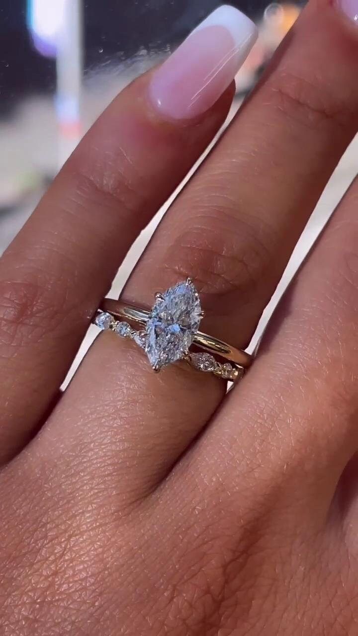 a woman's hand with a ring on it and a diamond in the middle