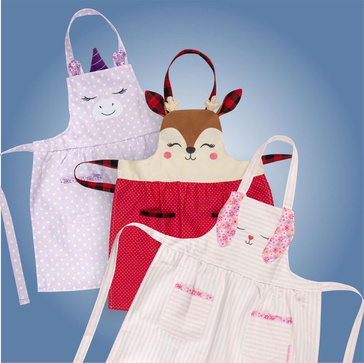 three aprons with different designs on them, one has a cat and the other has a deer