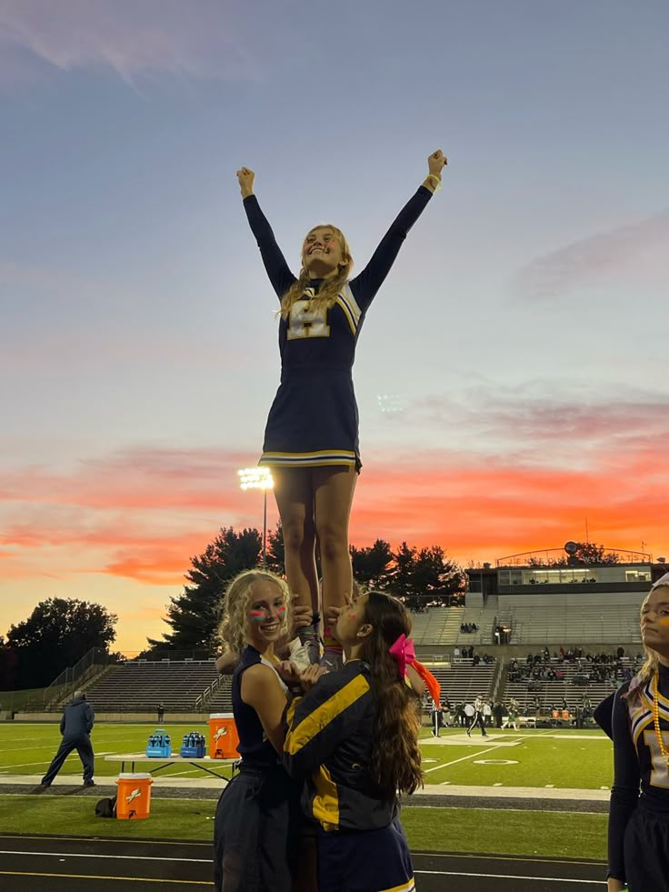 the cheerleaders are standing on top of each other