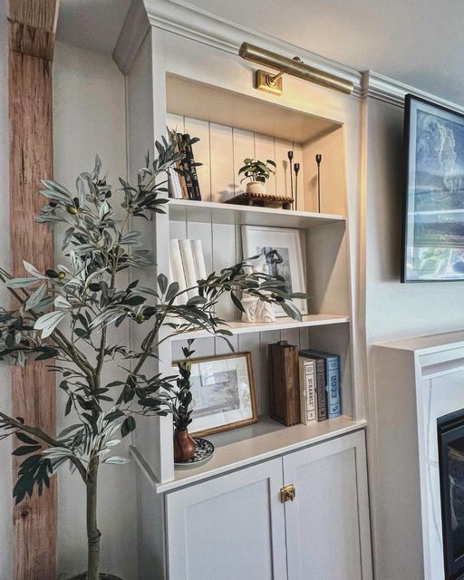 a living room filled with furniture and a flat screen tv mounted on the wall above a fireplace