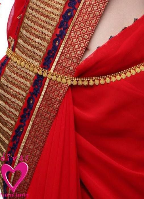 a woman wearing a red sari with gold and blue details on the neckline