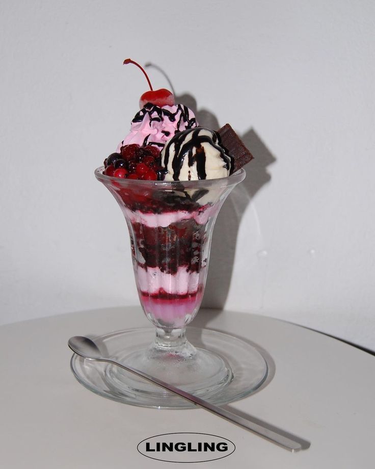 an ice cream sundae with cherries, chocolate and whipped cream in a glass dish