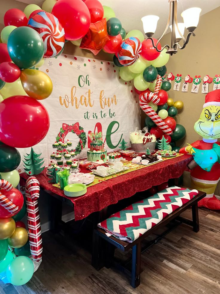 a christmas themed party with balloons, candy canes and dr seuss's hat