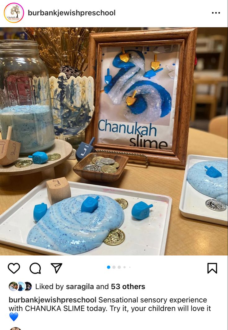 a table topped with blue and white items next to a glass jar filled with liquid