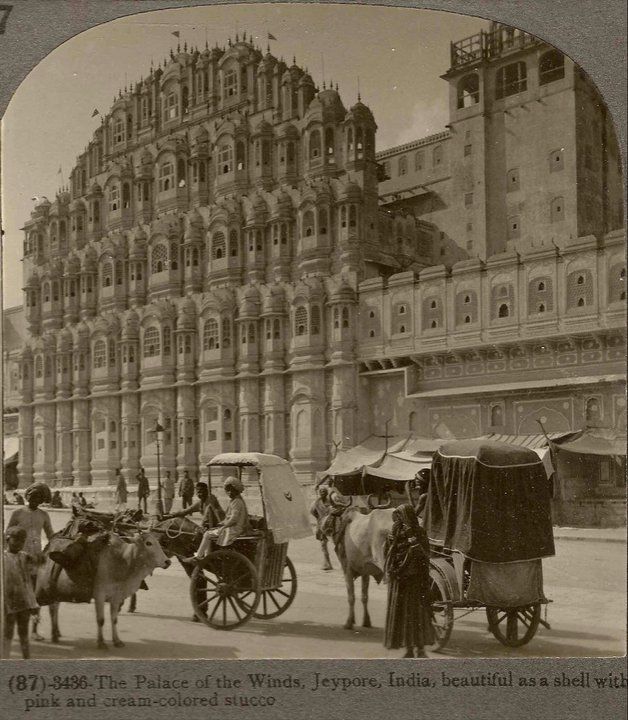 an old black and white photo of horse drawn carriages in front of a large building