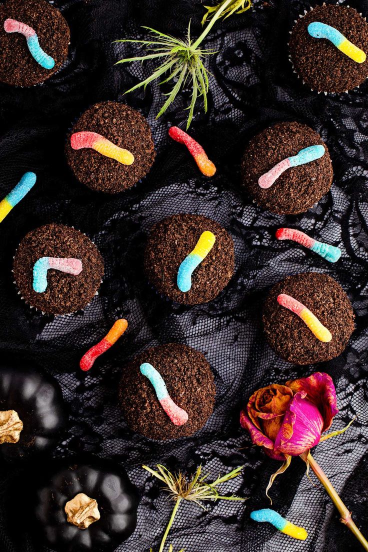 chocolate cupcakes with colorful frosting and sprinkles on black lace