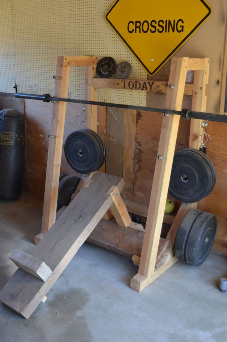 a crossfit gym with two squats and one barbell on the ground