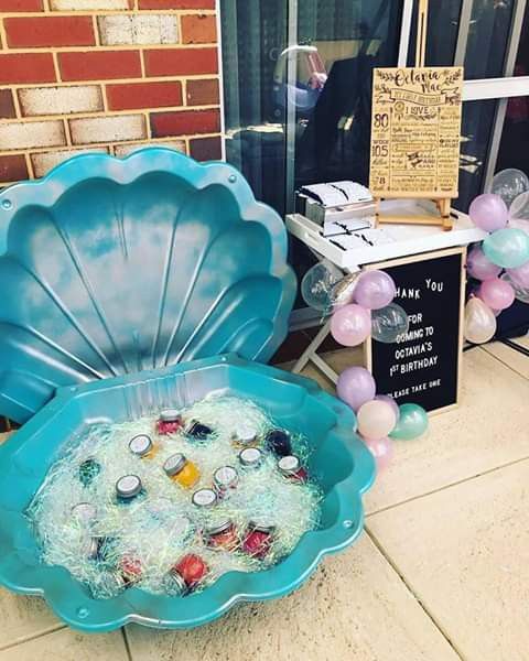 there is a large blue bowl filled with confetti and other items on the ground