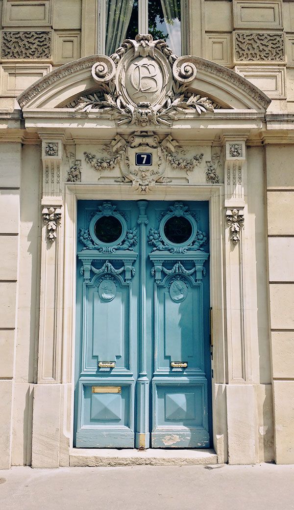 an old building with two large blue doors