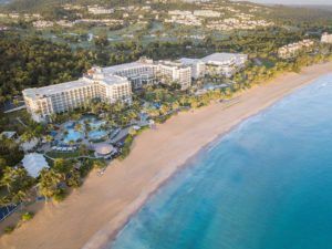 an aerial view of the resort and beach