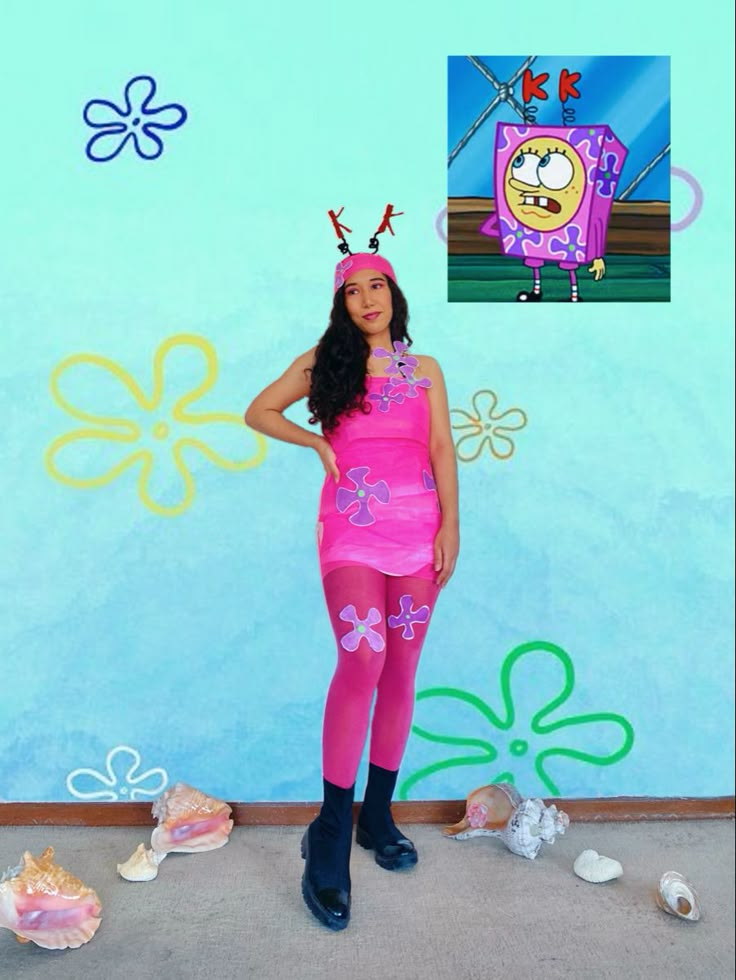 a girl in pink is standing next to a wall with spongebob on it