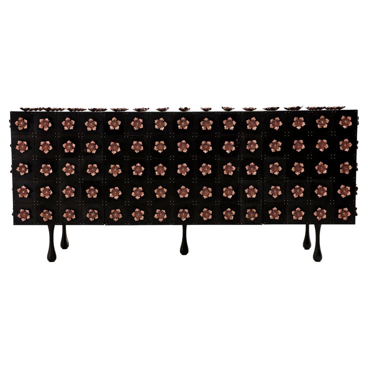 a black and brown flowered headboard with long legs