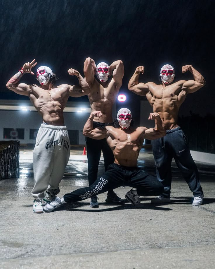 three men with masks on their faces posing for the camera in front of a building