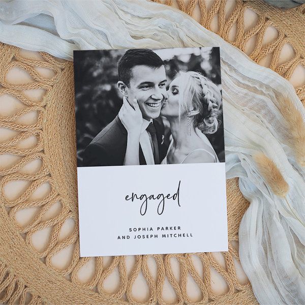 an engagement photo is displayed on top of a lace doily with a card that reads engaged