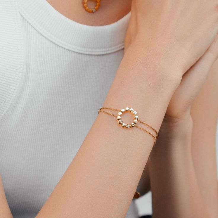 Crafted from high-quality recycled 14ct gold vermeil, this bracelet features a beautifully designed circular motif adorned with a single white cubic zirconia, adding just the right amount of sparkle.  The delicate double chain adds a touch of sophistication, making this gold vermeil bracelet perfect for any occasion, from casual outings to special events. Its adjustable clasp, ensures a comfortable fit.  Available in sterling silver & 14ct gold vermeil. Designed in the UK Crafted in recycled 14c Timeless Design Jewelry Gift, Yellow Gold Recycled Gold Bracelets, Fine Jewelry Gold Plated Diamond Bracelet, Elegant Sterling Silver Circle Bracelets, Minimalist Recycled Gold Round Bracelets, Modern Diamond Bracelet With Adjustable Chain, Modern Diamond Bracelet With Round Strap, Minimalist Recycled Gold Bracelets, Dainty Yellow Gold Circular Jewelry