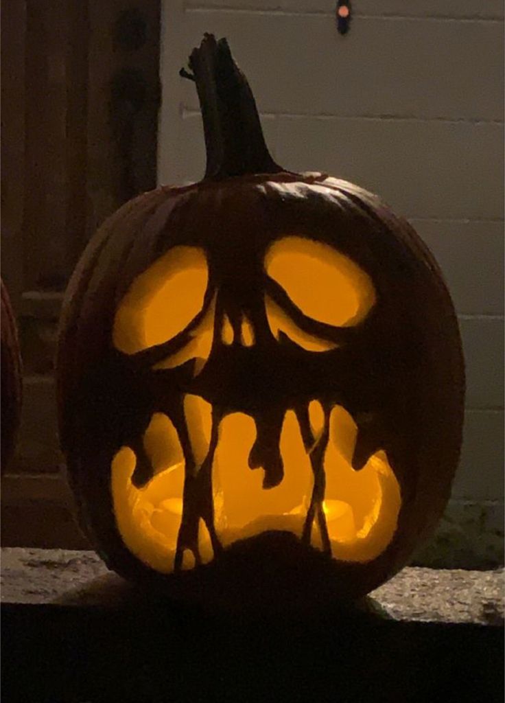 a carved pumpkin with scary faces on it