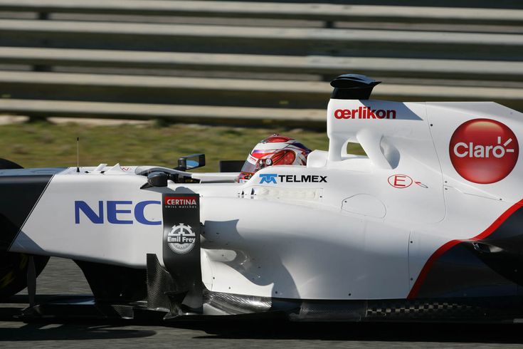 a man driving a race car on a track