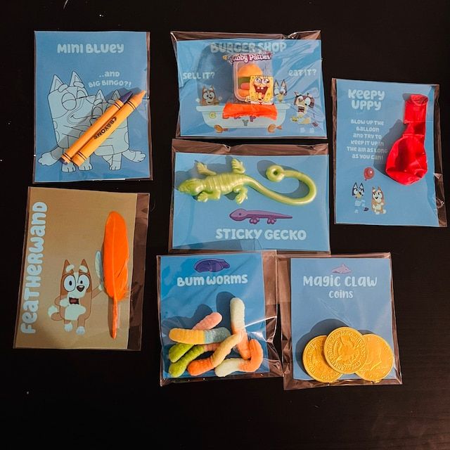 several different items are shown in plastic bags on a black surface, including toothbrushes and gummy bears