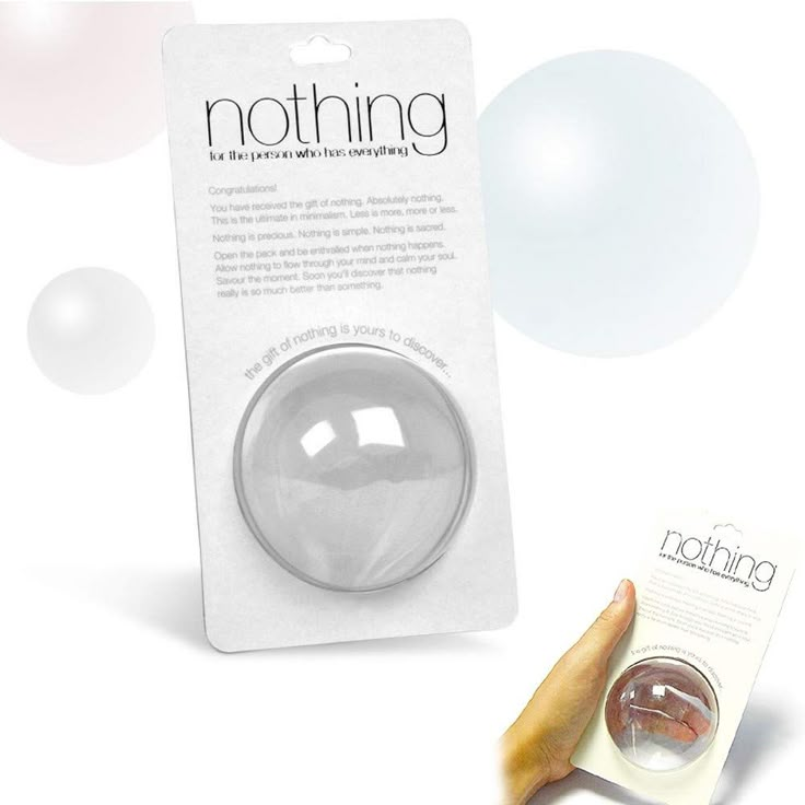 a hand holding a white ball in front of a package with the word nothing on it