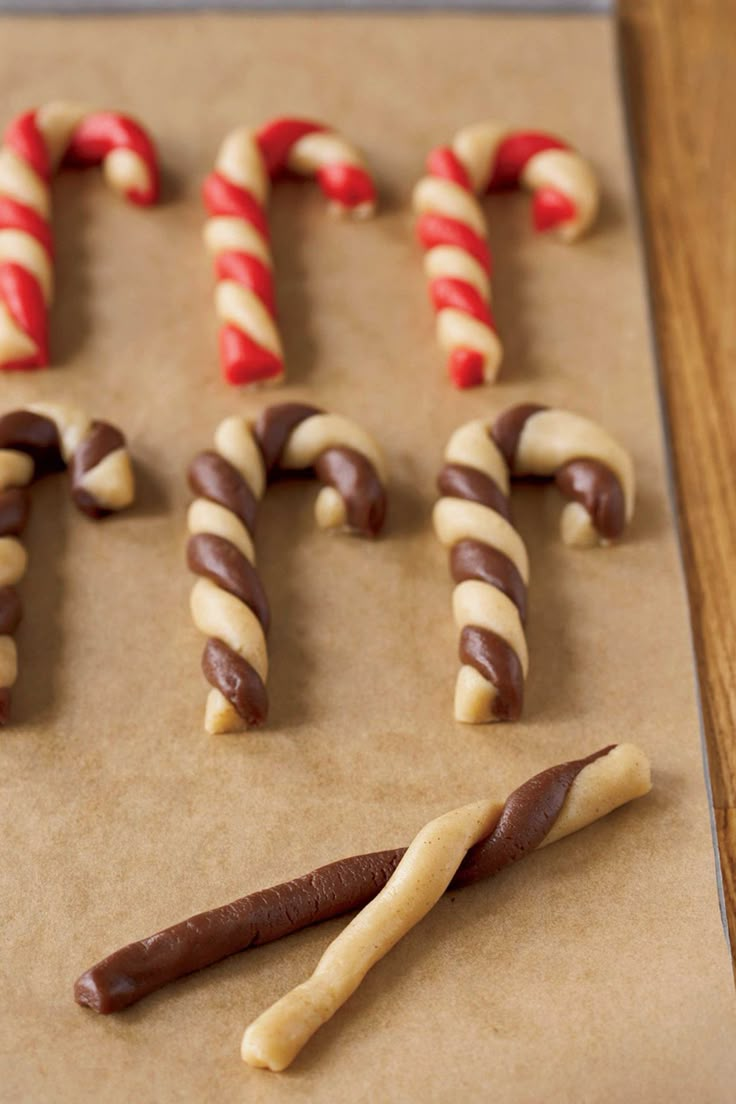 there are many candy canes on top of the cookie sheet and one is chocolate