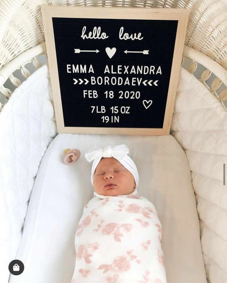 a baby is laying in a crib next to a chalkboard that says hello love