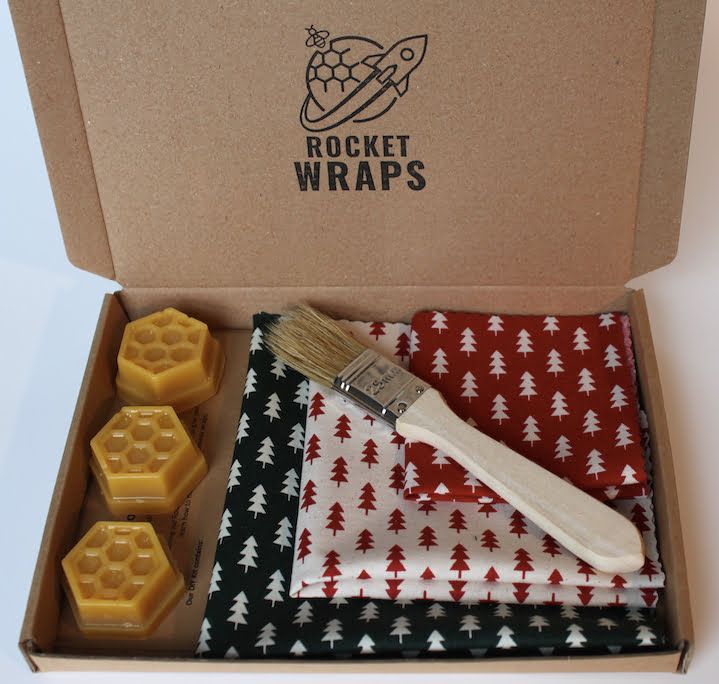 an open box containing wax and beeswapes with a brush in the middle one