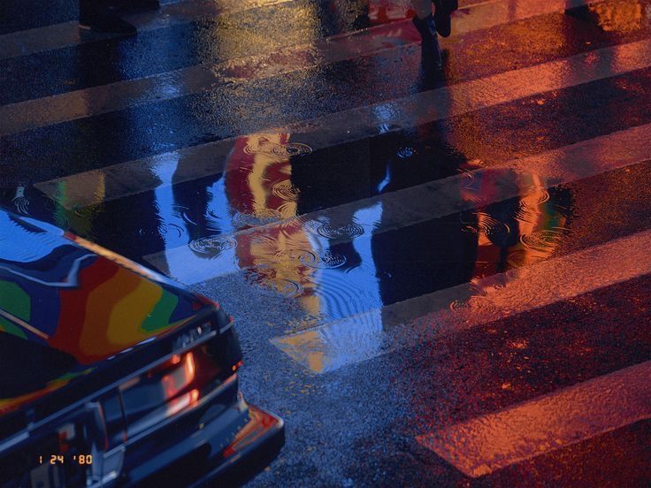 people crossing the street in the rain with umbrellas