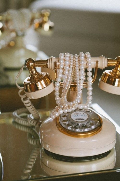 an old fashioned phone with pearls on it