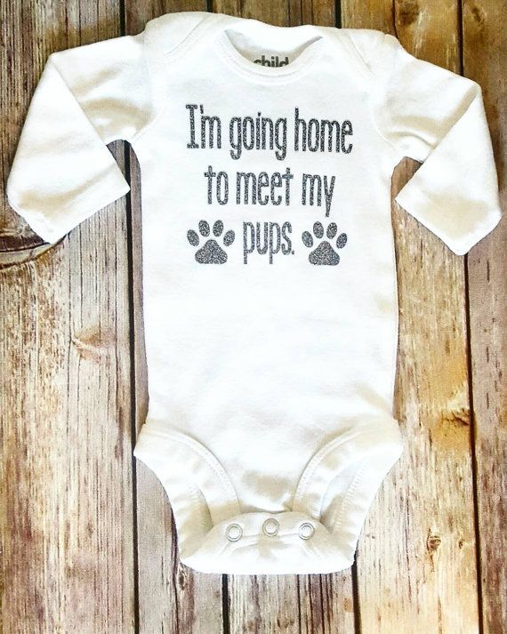 a baby bodysuit that says i'm going home to meet my pups