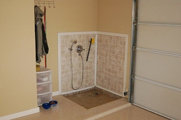 a bathroom with tiled walls and flooring next to a door that leads to a closet