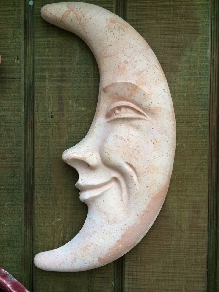 a statue of a crescent moon with a human's face