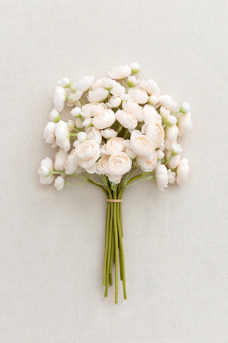 a bouquet of white flowers sitting on top of a table