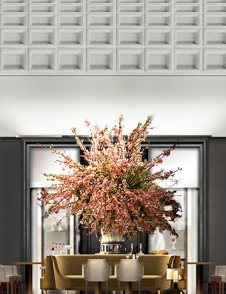 a dining room table with chairs and a vase filled with flowers on top of it