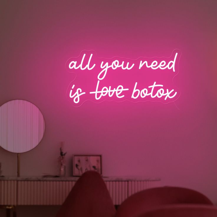 a pink neon sign that says all you need is love botox on the wall