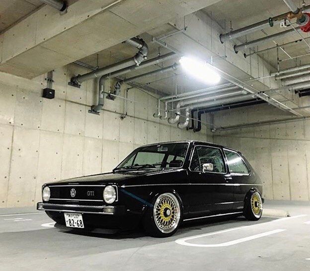 a black car parked in a parking garage