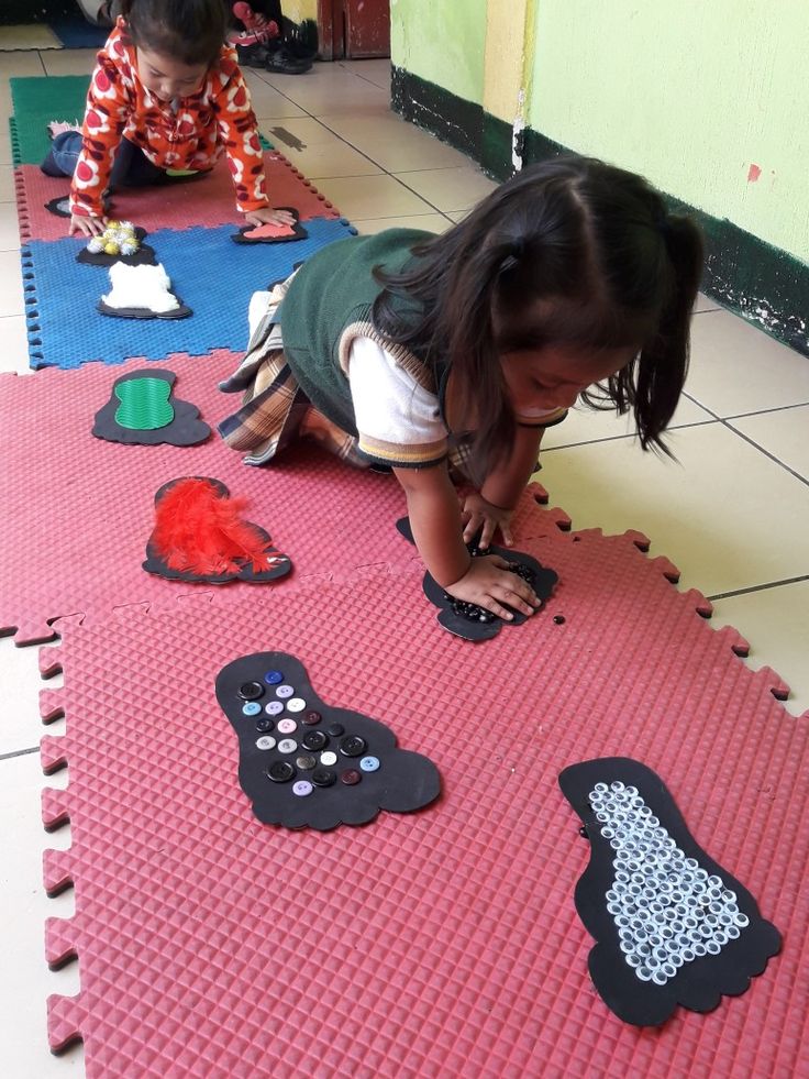 two children are playing with toys on the floor