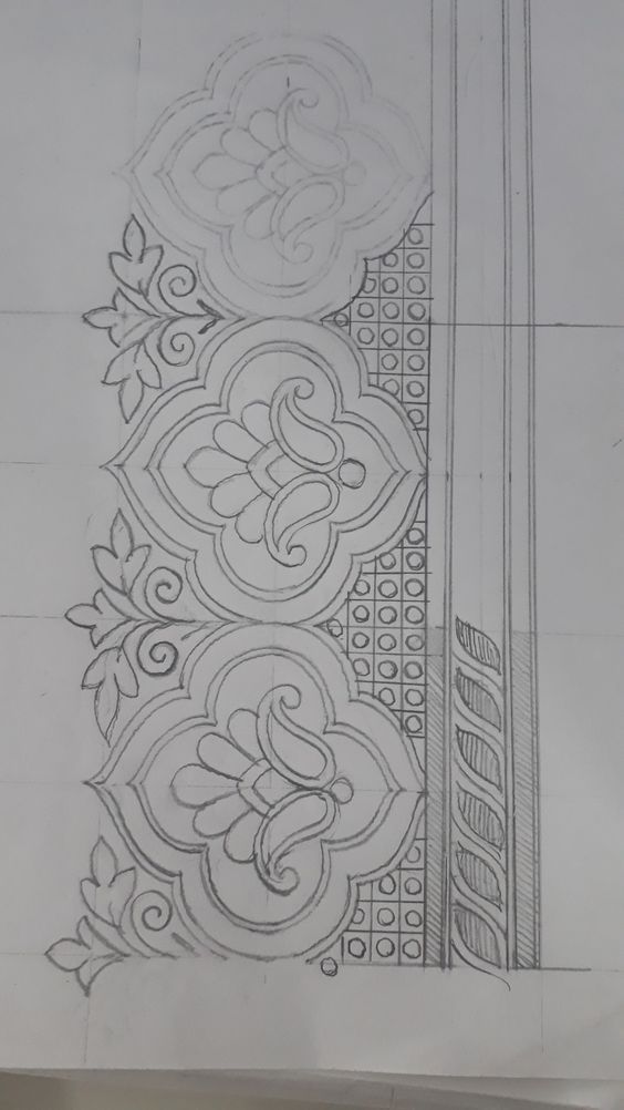 a pencil drawing of a design on paper with an ornamental motif in the middle and bottom corner