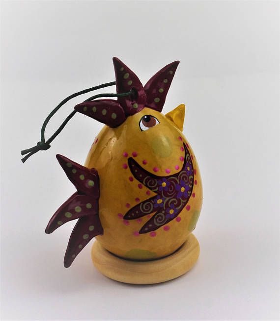 a ceramic figurine that looks like a fish with polka dots on it's head