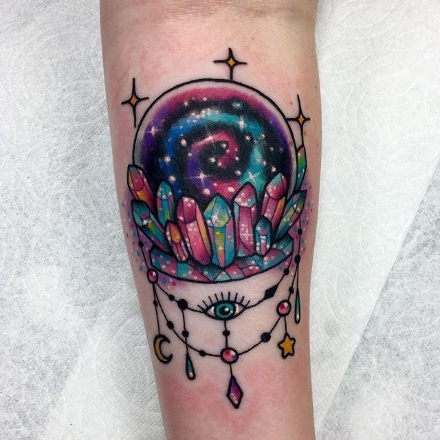 a colorful tattoo on the leg of a woman with an eye and stars in it