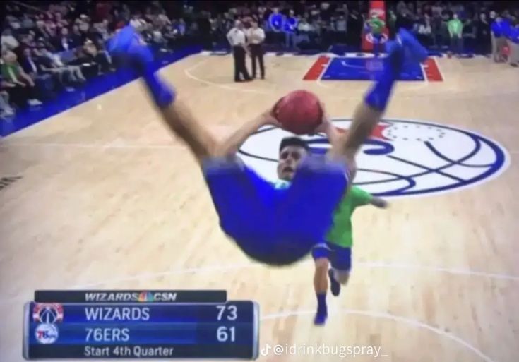 a basketball player is in mid air after hitting the ball during a game on tv